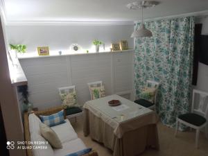 a dining room with a table and chairs at CASA ENROCADA in Setenil