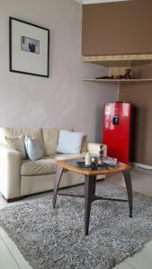 a living room with a couch and a coffee table at Limbila House in Cape Town
