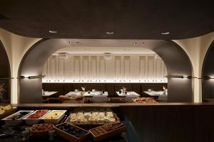 a bakery with a buffet of different types of food at Teight Hotel in Thessaloniki