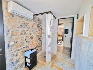 a room with a stone wall and a air conditioner at Casa Ginestra in Lerici