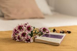 a book sitting on top of a table with flowers at Rooms Vita in Granada