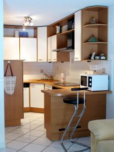 cocina con armarios de madera y encimera en 2P 4* 58m2 face au Lac, en Aix-les-Bains