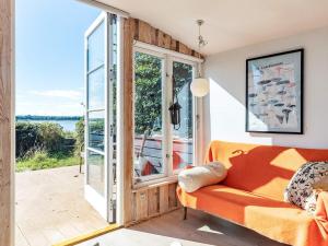 - un salon avec un canapé et une grande fenêtre dans l'établissement Holiday home Bogense II, à Bogense