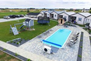 an aerial view of a pool and a playground at holiday home, Gaski in Gąski