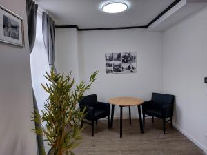 a meeting room with a table and two chairs at Hotel Vallis in Vaals