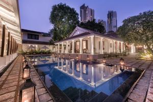 a house with a swimming pool in front of a building at Uga Residence - Colombo in Colombo