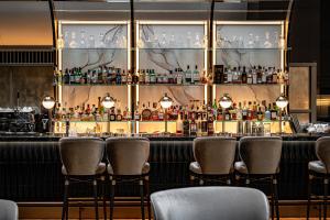 a bar with chairs in a room with a lot of bottles at The Strings by InterContinental, Tokyo, an IHG Hotel in Tokyo