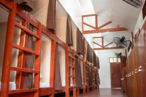 a row of bunk beds in a room at CocoRico Hostel in San Vicente