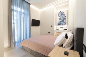 a bedroom with a bed and a large window at BillMar Luxury Apartment in the center of Gythio in Gythio