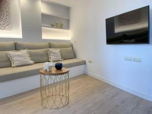 a living room with a couch and a table at Apartamento Calma Beach Home in Torremolinos