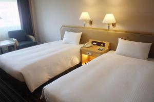 Voodi või voodid majutusasutuse Santos Hotel toas