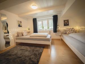 a bedroom with two beds and a window with lights at Ferienhaus Siebenfelsen in Elzach