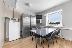 a kitchen with a table and a refrigerator at Reldor Motell in Pärnu