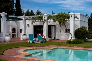 a house with a swimming pool in the yard at Greenhill Farm Manor House Plettenberg Bay - Private House Sleeps 8 in Plettenberg Bay