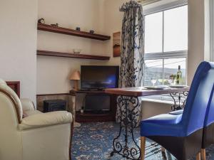 a living room with a table and a window at Grosmont Apartment in Commondale