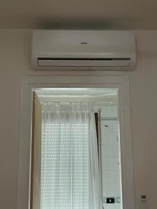 a bathroom with a window and a ceiling at Charlotte room in Bassano del Grappa