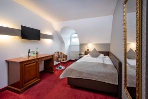 Postel nebo postele na pokoji v ubytování Hotel am Mirabellplatz
