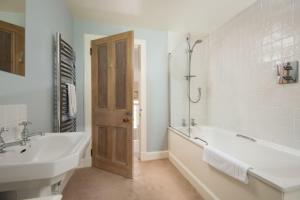 a white bathroom with a tub and a sink at Crailing Cottage in Jedburgh +15 photos