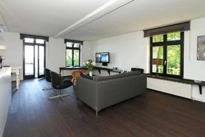 a living room with a couch and a table at Villa Schering App 4 Black White in Heringsdorf