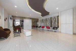 a large lobby with couches and chairs in a building at Collection O 91714 Hotel Alden in Makassar