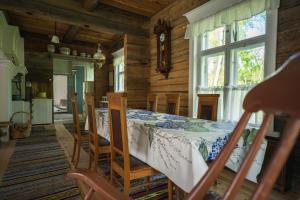 a dining room with a table and chairs at Unique loghouse and wood heated sauna in Ii in Ii