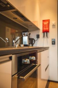 a kitchen with a counter with a stove top oven at Skihouse Apartment in Levi