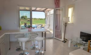 a kitchen with a table and stools in a room at IRIS HOME 4 in Paralia Katerinis