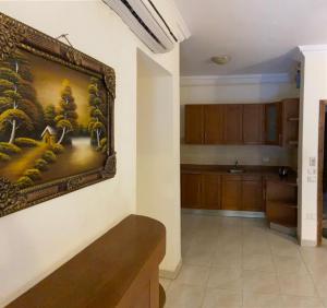 a kitchen with a painting hanging on the wall at Bahga Palace 3 Residential Apartments in Hurghada