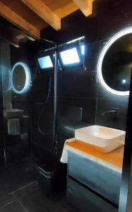 a bathroom with a sink and a shower at Casa d´ Avó Glória in Alvoco das Várzeas
