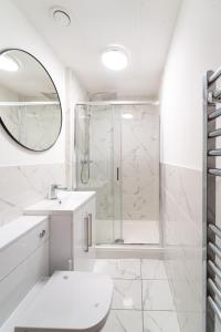 a white bathroom with a shower and a toilet at Royal House Luxury Apartments - Chester in Chester