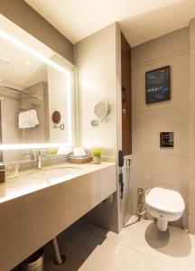 a bathroom with a sink and a toilet at Clarks Inn Express Ludhiana in Ludhiana