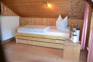 a bedroom with a bed in a wooden cabin at Auszeit by Annette in Hohenwarth
