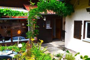 a garden in front of a house with plants at Auszeit by Annette in Hohenwarth