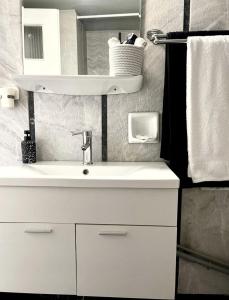 a bathroom with a white sink and a mirror at Marine Apartment with sea & port view! in Volos