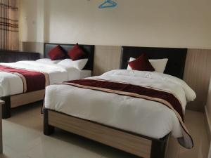 מיטה או מיטות בחדר ב-Om Bramha Hotel