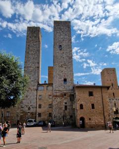 a group of people standing outside of a castle at Torre Salvucci Maggiore Medieval Tower Experience in San Gimignano