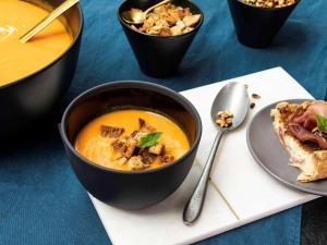 a bowl of soup next to a plate of food at ibis Styles Golden Sands Roomer Hotel in Golden Sands