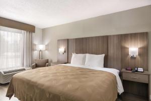 a hotel room with a large bed and a window at Quality Inn in Emporia