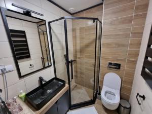 a bathroom with a shower and a toilet and a sink at Rajski kutak - Centar in Kopaonik +69 photos