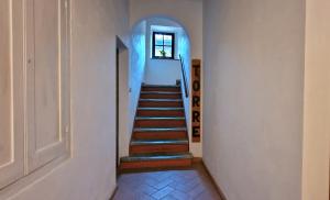a staircase in a house with a stair case at Torre Salvucci Maggiore Medieval Tower Experience in San Gimignano