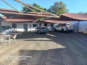 a parking lot with cars parked under a tent at Morning flair Bed and Breakfast in Bloemfontein