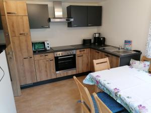 a kitchen with a table and a small kitchen with a table and a tableablish at Ferienwohnung Weppermühle 