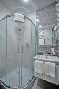 a bathroom with a shower and a sink at Continental Hotel Samarkand in Samarkand