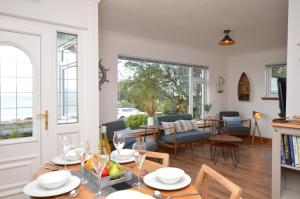 a dining room and living room with a table and chairs at Bay View in Lochgilphead