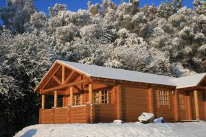a log cabin in the snow at BCC Loch Ness Log Cabins in Bearnock