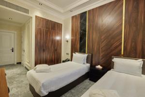 Кровать или кровати в номере Continental Hotel Samarkand