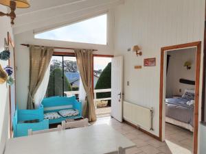 a room with a bedroom and a bed and a window at Cabañas Lomas de Pinares in Pichilemu