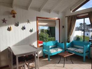 a porch with two chairs and a table and a mirror at Cabañas Lomas de Pinares in Pichilemu