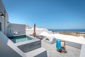 a balcony with a swimming pool and chairs on a house at Casa Vicenza - Private house with Jacuzzi and Aegean View in Foinikiá