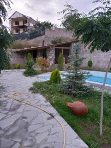 a pool with a hose in front of a house at Villa Maria Dilijan in Dilijan